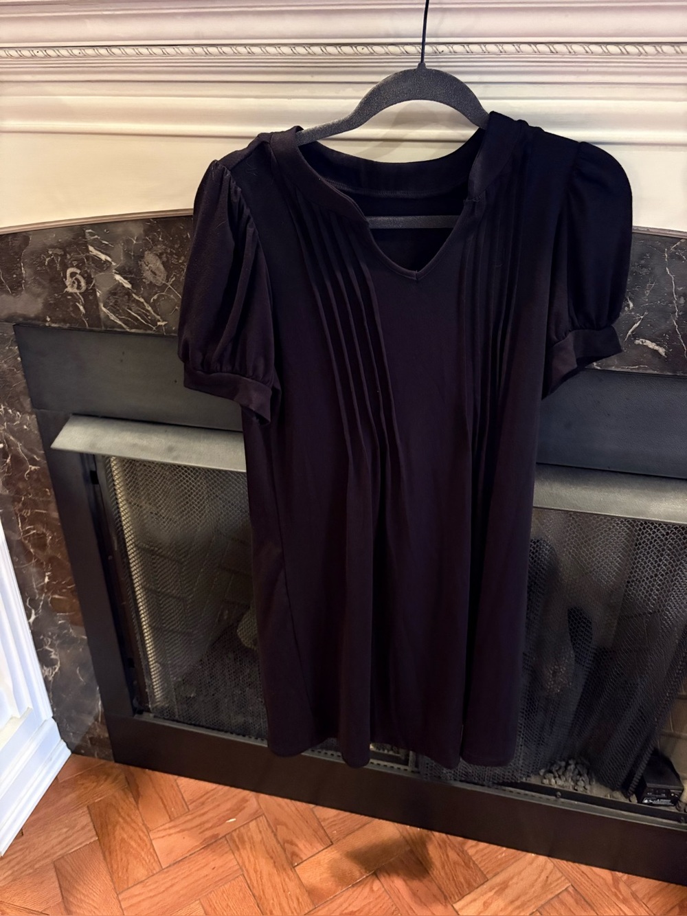Black short- sleeve dress v-neckline vertical pin tuck pleat detailing down the